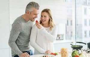 mid age couple together in kitchen