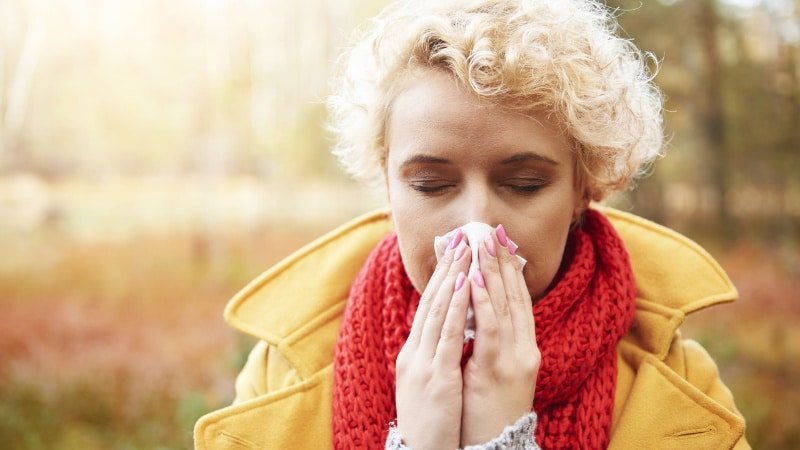 woman blowing her nose